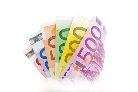 Fanned multicolored euro banknotes isolated on a white background
