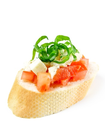 Bruschetta with fresh diced tomatoes, mozzarella and fresh basil isolated on whiteの写真素材
