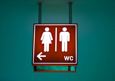 Men and women toilet sign with an arrow showing directionの写真素材