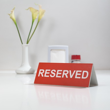 Flawer and sign on the table Reserved