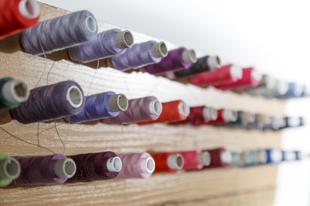 Colorful thread spools used in fabric and textile industry.