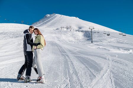 Young happy couple in snowy mountains. Winter sport vacationの写真素材