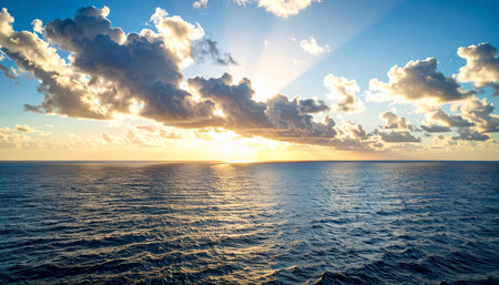Sunset over the sea with clouds and sun rays. Beautiful natural background.の素材