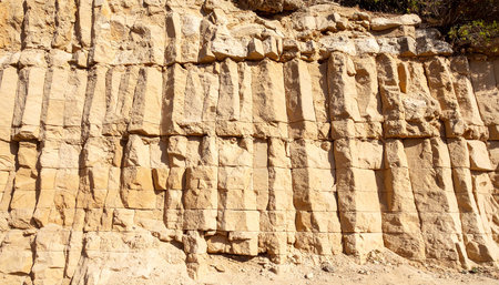 Ancient sandstone cliffs with inscriptions on them in the desert.の素材