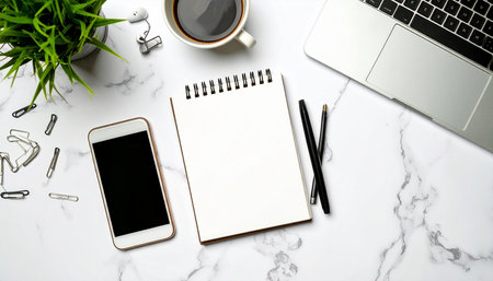 White office desk table with laptop, smartphone and coffee cup. Top view with copy space, flat layの素材