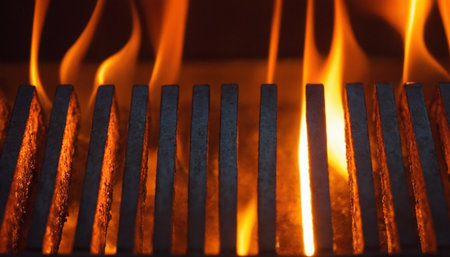 Close-up of a barbecue grill with flames in the background.の素材