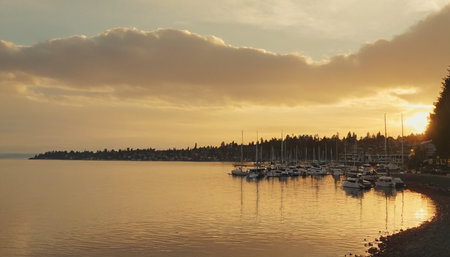 Sunset on the sea with sailboats and fishing boats in the foregroundの素材