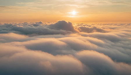Aerial view of white fluffy clouds in the blue sky at sunsetの素材