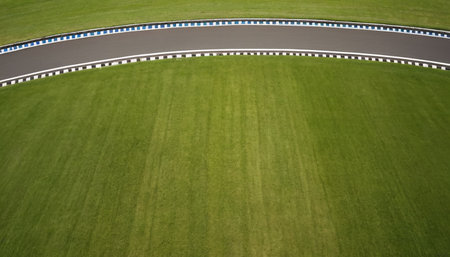 Aerial view of a race track with markings on the green grassの素材