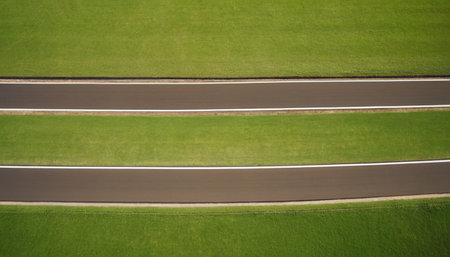 Aerial view of a race track in a green grassy fieldの素材