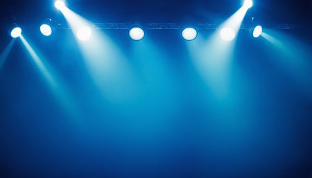 Stage lights on a blue background. The stage is lit by spotlights.の素材