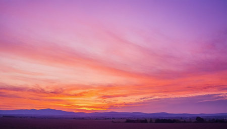 Sunset in the field with mountains in the background. Landscape.の素材