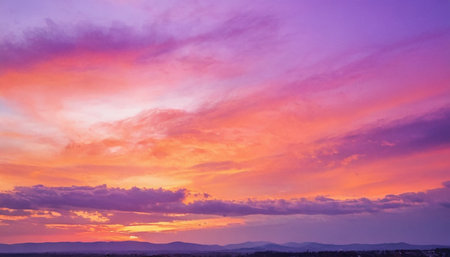 Colorful sunset over the mountain range. Beautiful sky with clouds.の素材