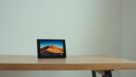 Tablet pc with image of dunes on wooden table in living roomの素材
