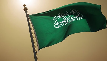 Saudi Arabia waving flag on blue sky background. 3d rendering.の素材