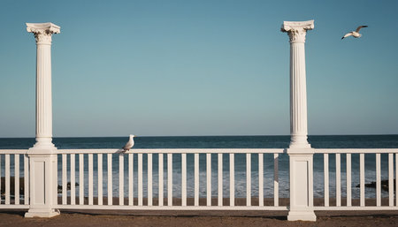 White columns and seagulls on the background of the seaの素材