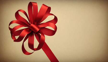Red ribbon bow on brown background with copy space for your text.の素材