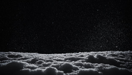 Snowfall on dark background. Snowflakes in the air.の素材
