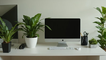 Modern workplace with computer, stationery and houseplants on tableの素材