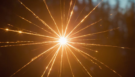 golden sparkler on dark background, shallow depth of field.の素材