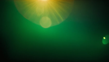 green bokeh background with sun ray and lens flare effect.の素材