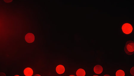 Red bokeh lights on black background. Christmas and New Year holidays concept.の素材
