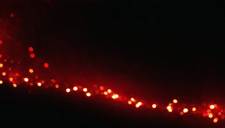 Red bokeh on black background. Christmas and New Year conceptの素材