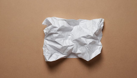 Crumpled paper on brown background. Top view, copy spaceの素材