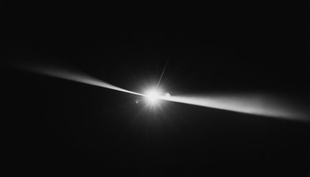 black and white image of sunbeam in the night sky background.の素材