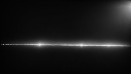 Black and white image of a laser beam on a black background.の素材