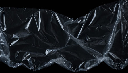 close up of a crumpled plastic bag isolated on black backgroundの素材