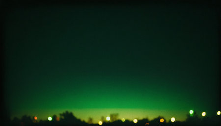 Night city lights bokeh defocused background. Green and black colorsの素材