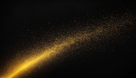 Abstract gold dust explosion on black background. Golden dust explode on black background.の素材