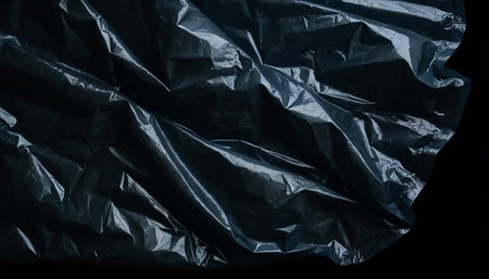 Black crumpled plastic bag. Abstract background and texture for design.の素材