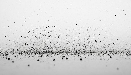 Black dust on a white background. Black particles fly in the air.の素材