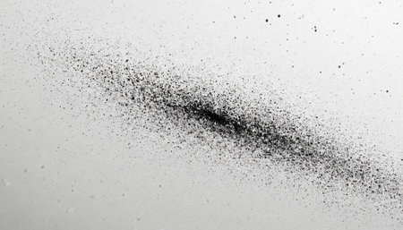 Black particles explosion isolated on white background.  Abstract dust overlay texture.の素材