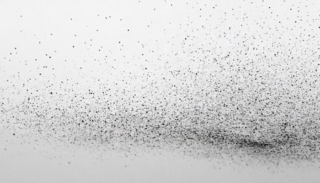 Black particles explosion isolated on white background.  Abstract dust overlay texture.の素材
