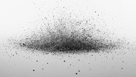 Black particles explosion isolated on white background. Abstract dust overlay texture.の素材