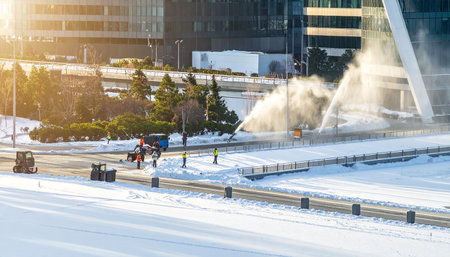 snowplow cleans the road in the city in winter.の素材