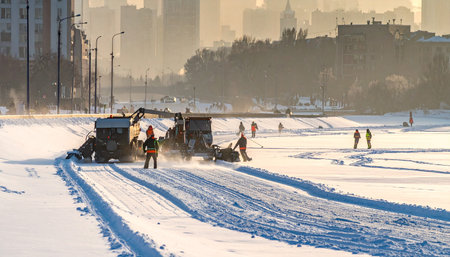 Snowplow cleans the road in the city. Winter landscape.の素材