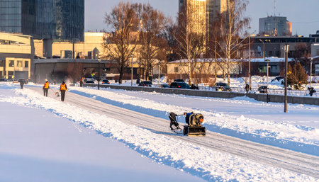 Workers clean snow from the road.の素材
