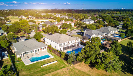 Aerial view of large luxury house with swimming pool in sunny day.の素材