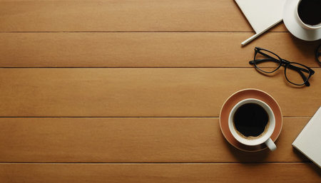 Coffee cup and notebook on wooden table. Top view with copy spaceの素材