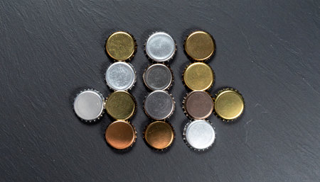 Bottle caps of beer on a black background. Top view.の素材