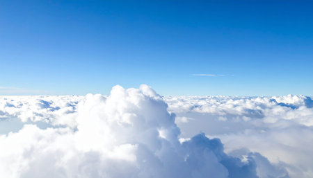 Blue sky and white clouds. View from the window of an airplaneの素材