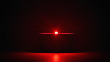 candle light in a dark room with red light on a black backgroundの素材