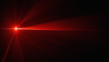 Red light flare on black background. Natural lens flare. Sun flash.の素材