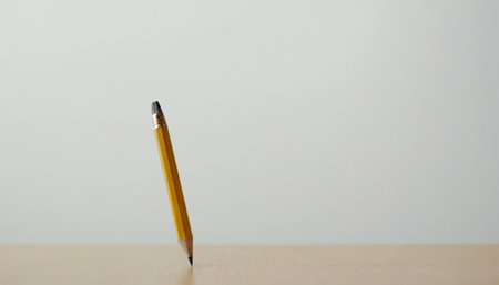 Pencil on wood table and white wall background, selective focus.の素材