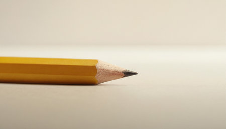 Close up of a yellow pencil on a white background with copy spaceの素材