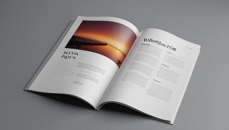 Open magazine with a picture of the sun on a gray background.の素材